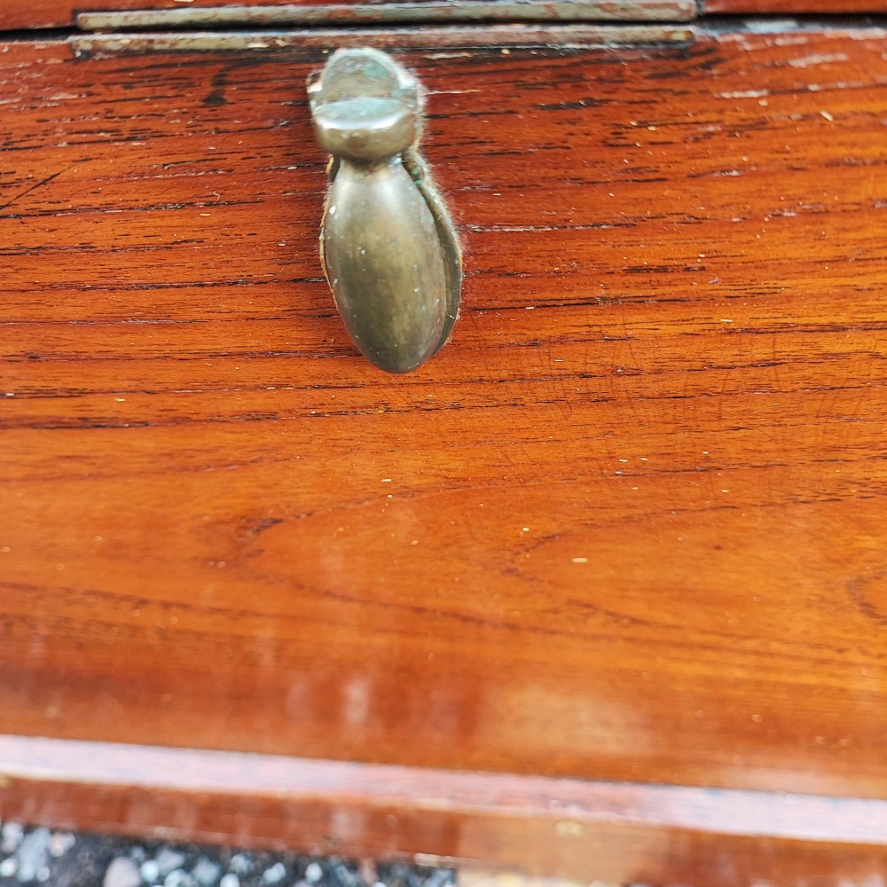 A rectangular warm brown teak sea chest featuring reinforced brass corner brackets and dovetail joinery. View IV
