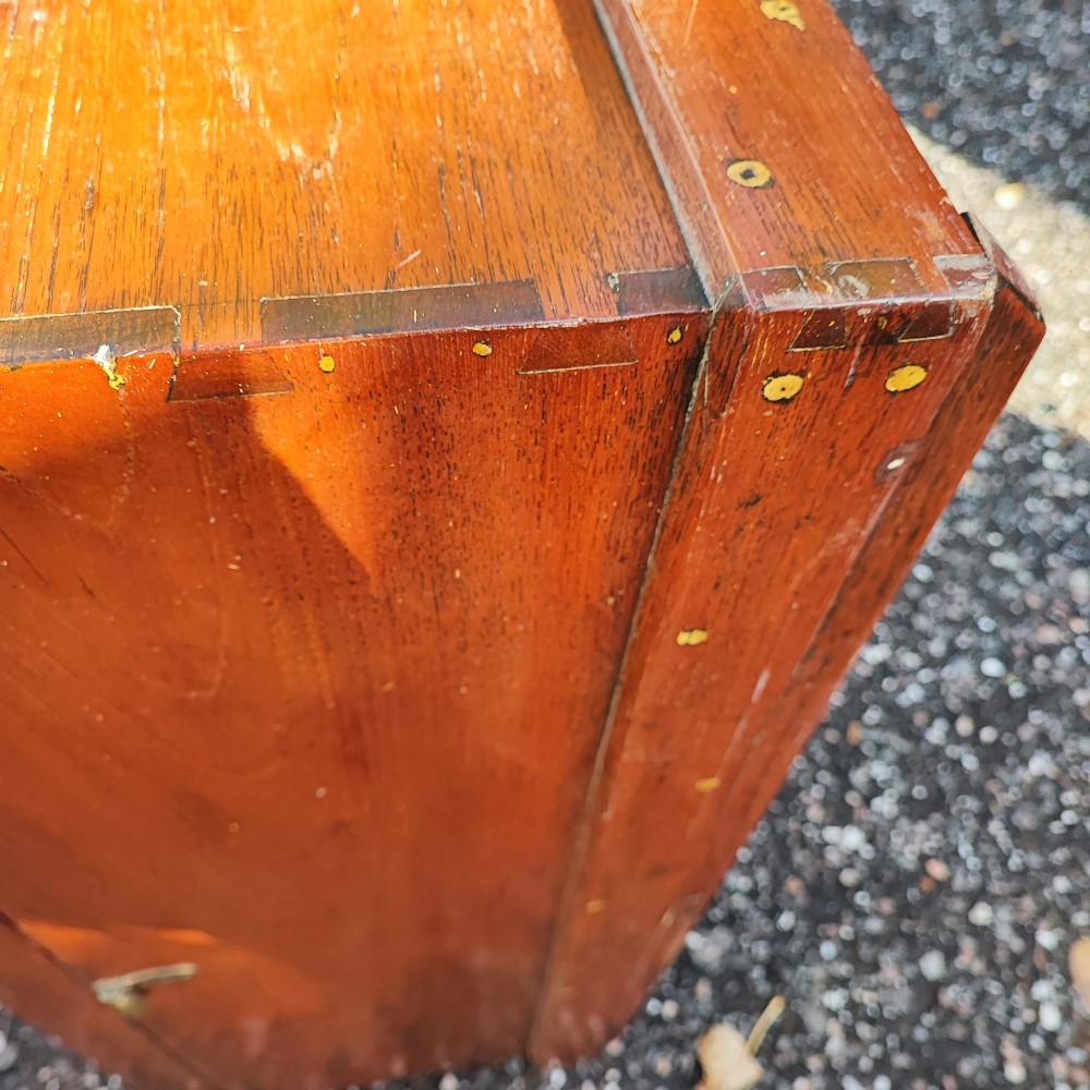 A rectangular warm brown teak sea chest featuring reinforced brass corner brackets and dovetail joinery. View XII