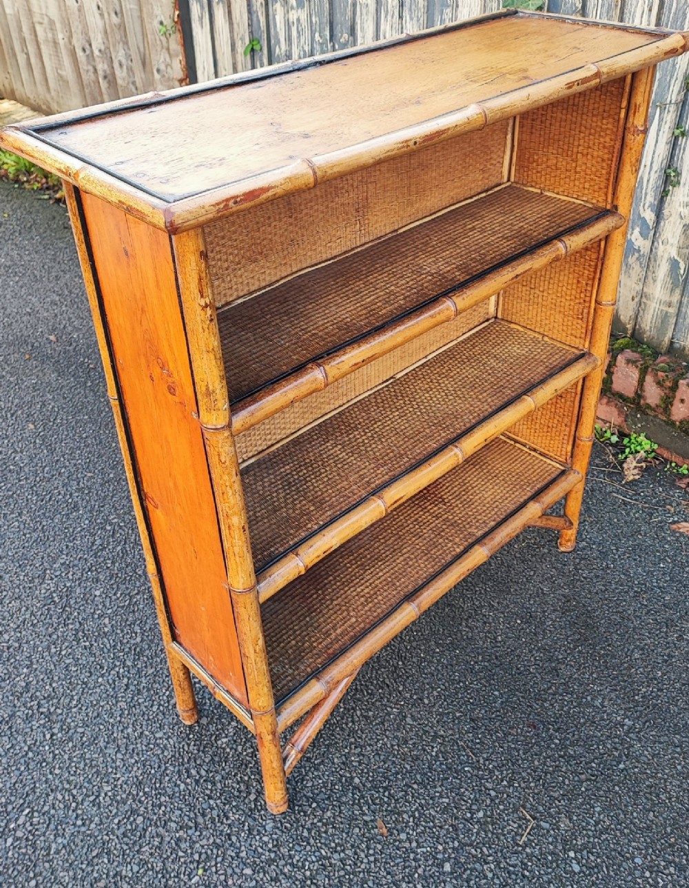 A late Victorian open bookcase featuring a bamboo cane frame, pine side panels, and three woven cane display shelves. View XI