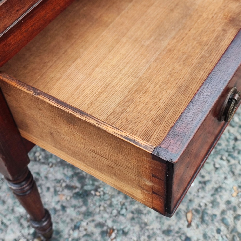 An Arts and Crafts ash timber washstand featuring a white marble top, green patterned tiled splashback, side towel rails, and turned legs. View VI