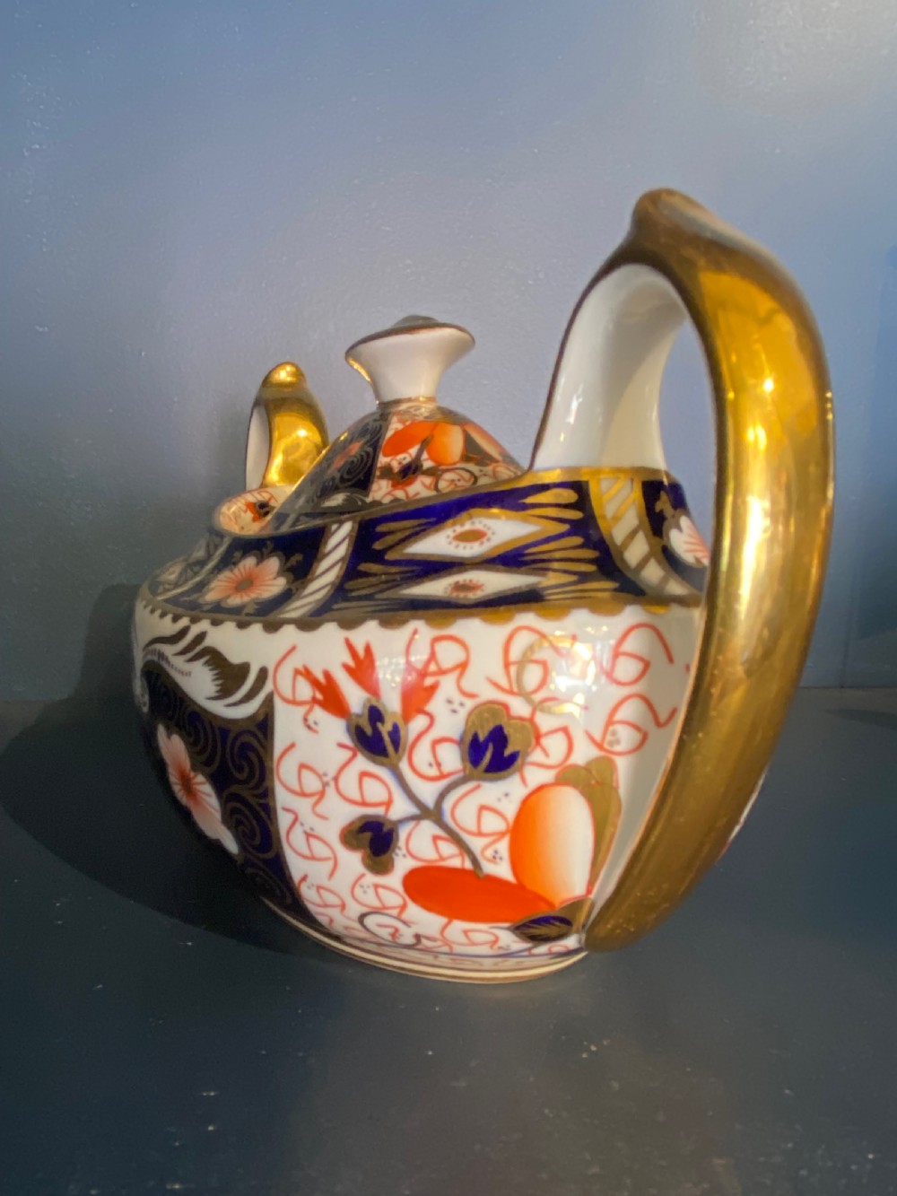 An antique Royal Crown Derby porcelain covered sugar bowl with twin handles, decorated in cobalt blue, iron red, and gilt Imari patterns. View II