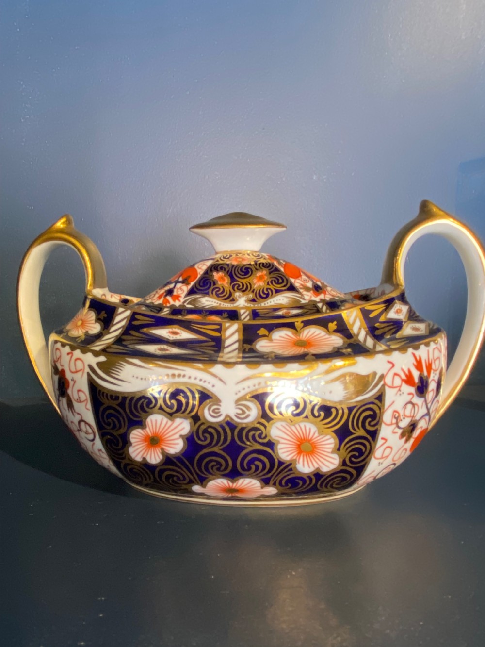 An antique Royal Crown Derby porcelain covered sugar bowl with twin handles, decorated in cobalt blue, iron red, and gilt Imari patterns. View III