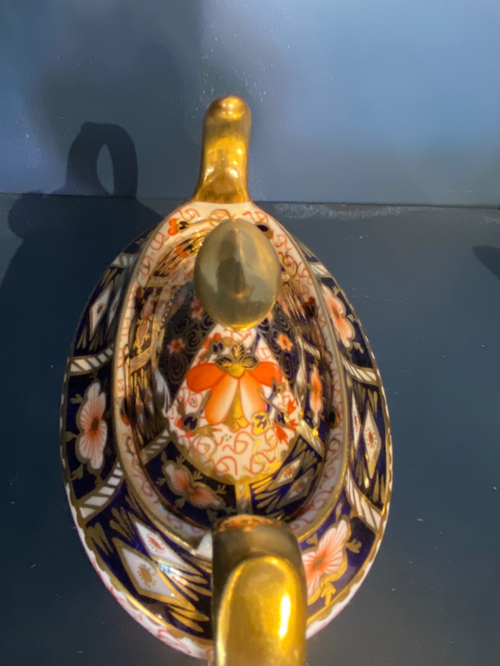 An antique Royal Crown Derby porcelain covered sugar bowl with twin handles, decorated in cobalt blue, iron red, and gilt Imari patterns. View V