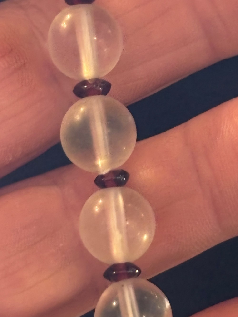 An Art Deco necklace composed of clear spherical rock crystal beads ending with a large round crystal disc pendant. View IV