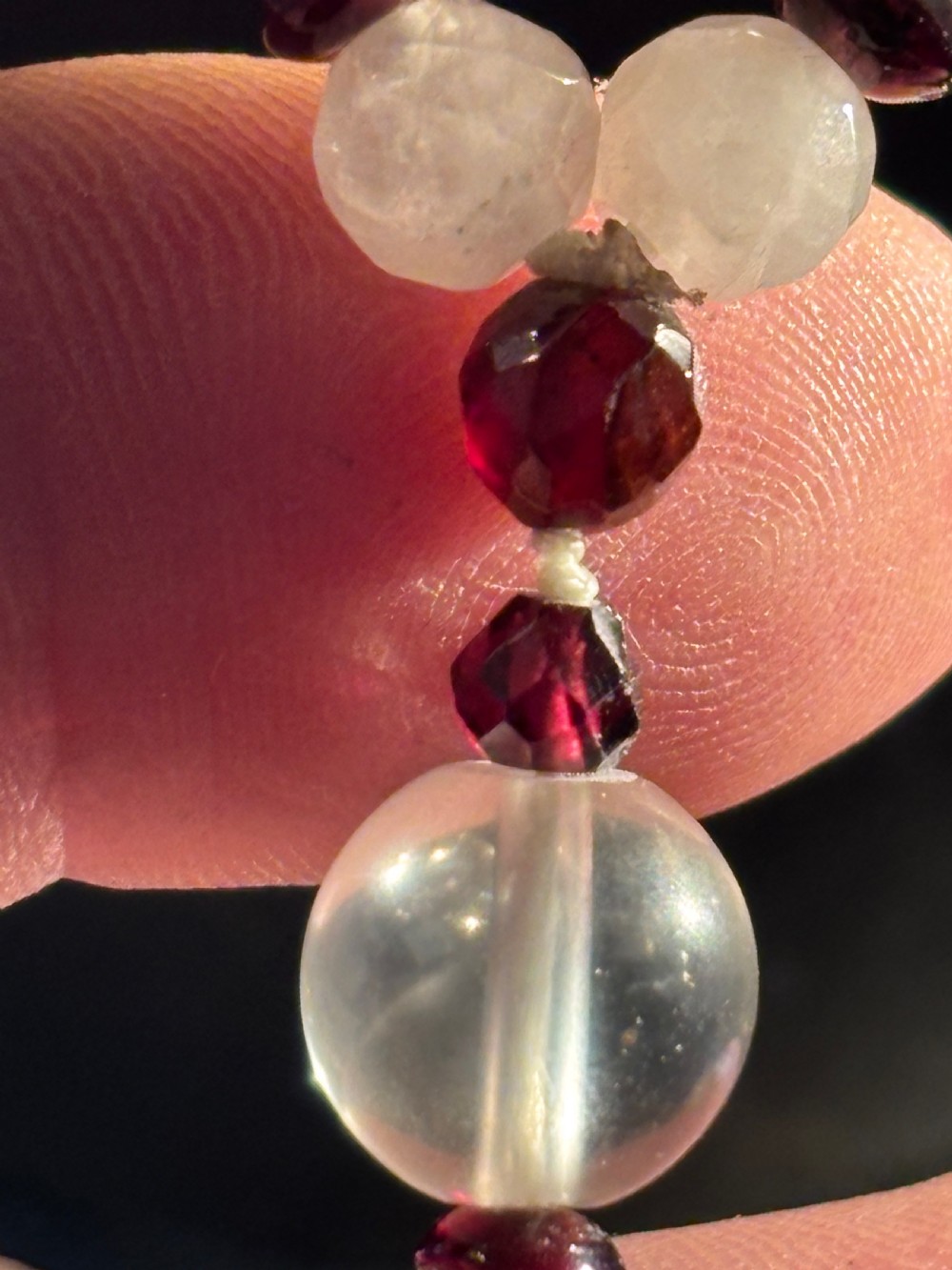 An Art Deco necklace composed of clear spherical rock crystal beads ending with a large round crystal disc pendant. View VIII