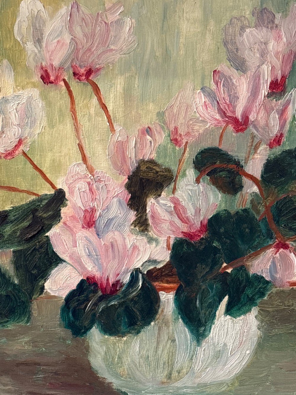 A framed mid-century oil painting on board depicting white and pink cyclamen flowers in a glass vase against a sage green background, signed by artist Winifred Turner. View IV