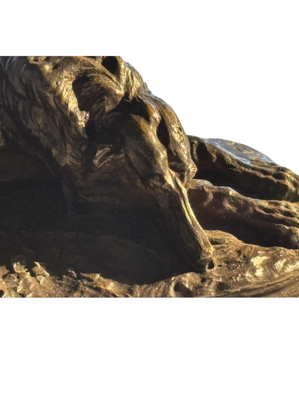 A dark patinated bronze sculpture of a reclining sighthound resting on a moulded dark marble plinth. View III