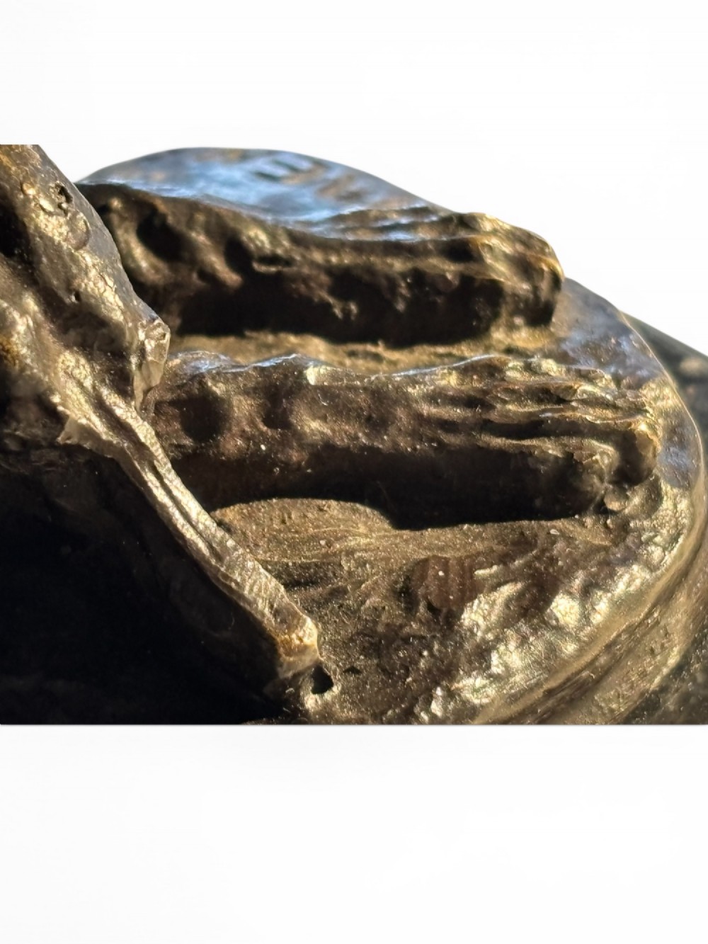 A dark patinated bronze sculpture of a reclining sighthound resting on a moulded dark marble plinth. View VIII