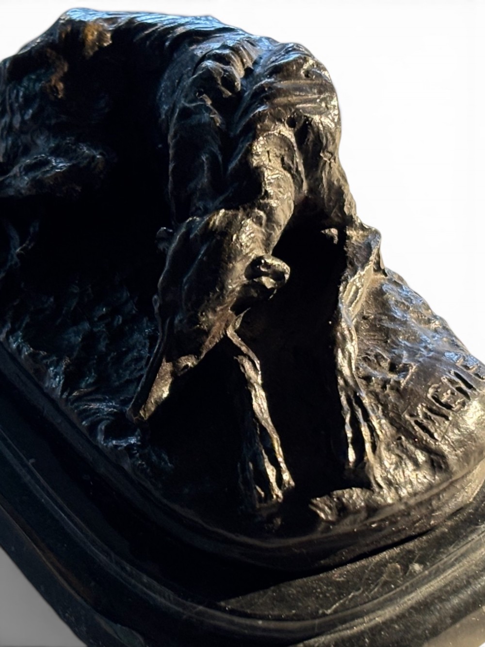 A dark patinated bronze sculpture of a reclining sighthound resting on a moulded dark marble plinth. View XI