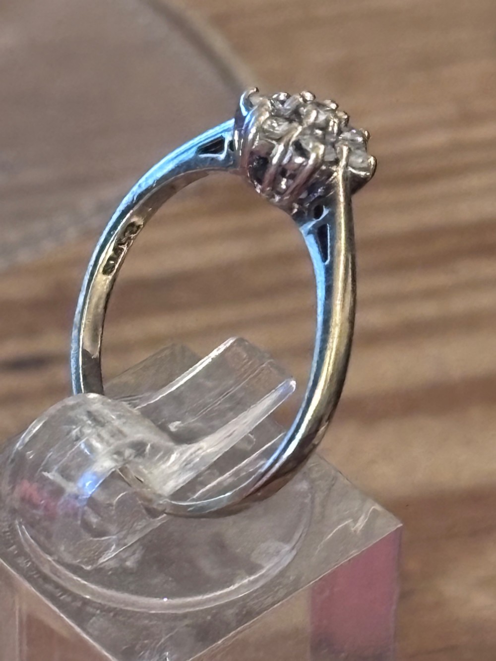 A vintage gold ring featuring a cluster of circular diamonds arranged in a floral rosette setting. View II