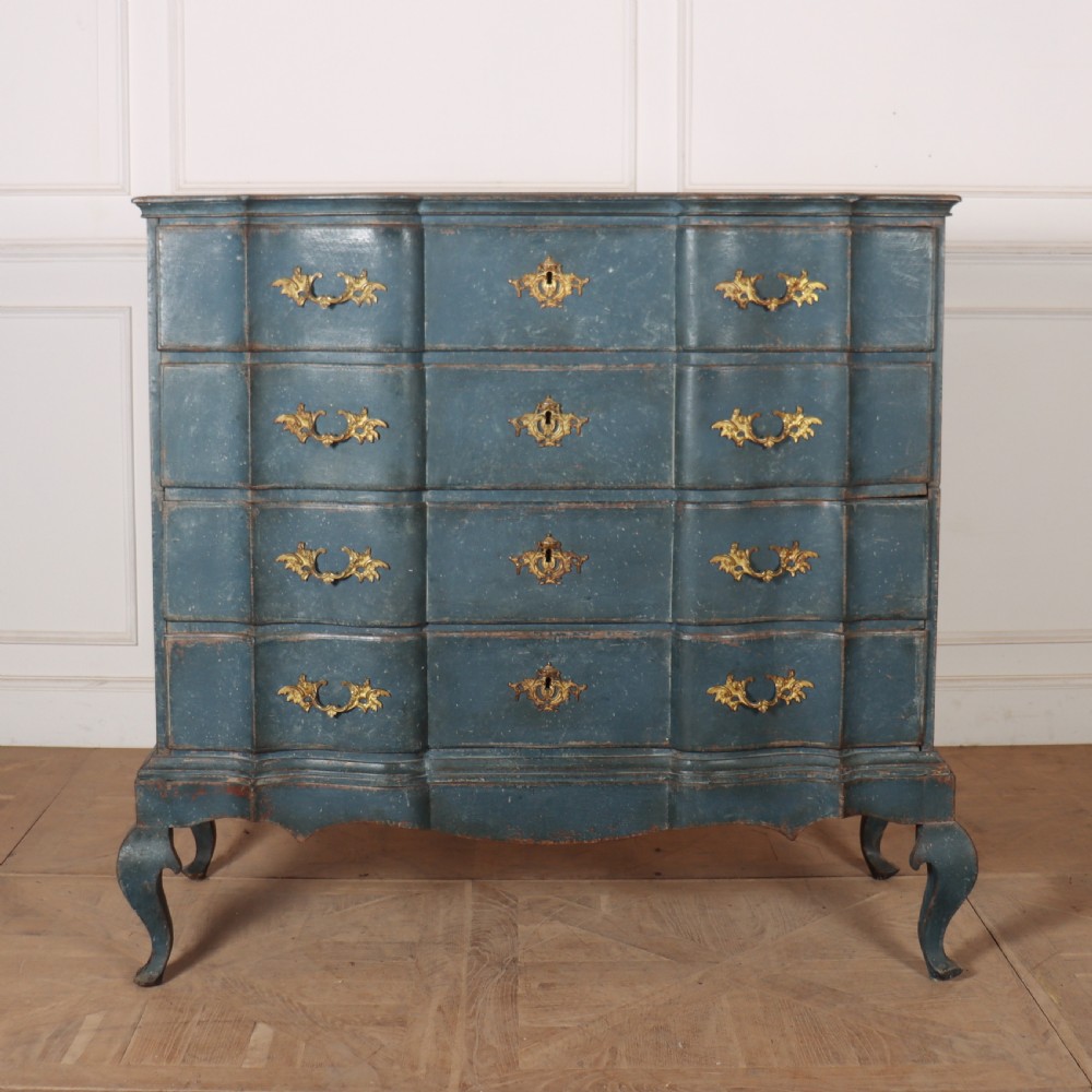 An 18th-century Danish blue-painted chest of drawers featuring a shaped serpentine front, gilt brass hardware, and cabriole legs.