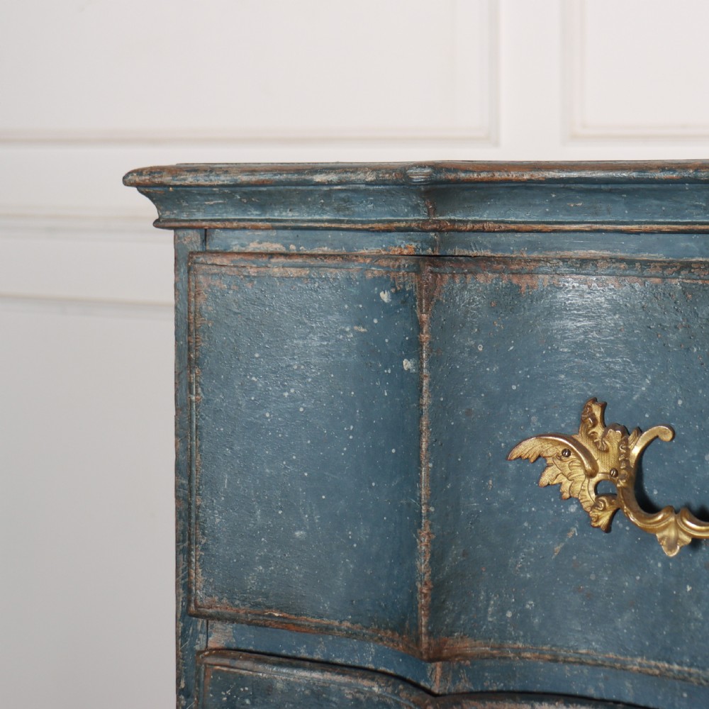 An 18th-century Danish blue-painted chest of drawers featuring a shaped serpentine front, gilt brass hardware, and cabriole legs. View II