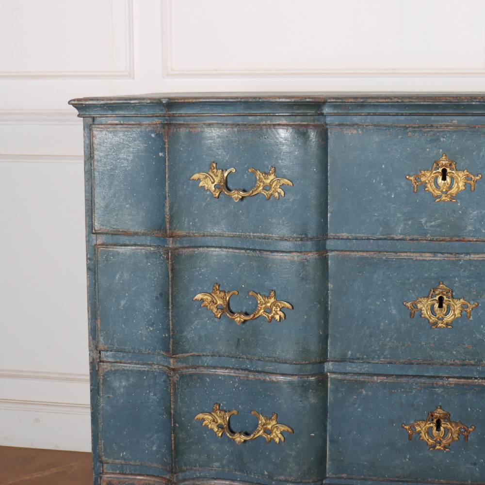 An 18th-century Danish blue-painted chest of drawers featuring a shaped serpentine front, gilt brass hardware, and cabriole legs. View V