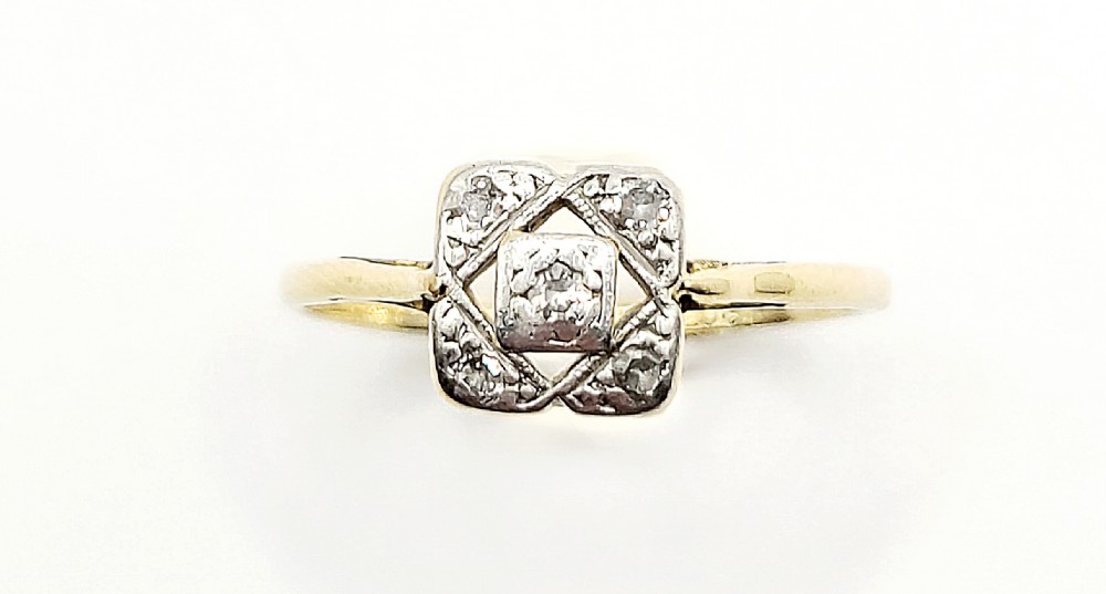 An Art Deco 18ct yellow gold ring featuring a square geometric platinum head set with small diamonds.