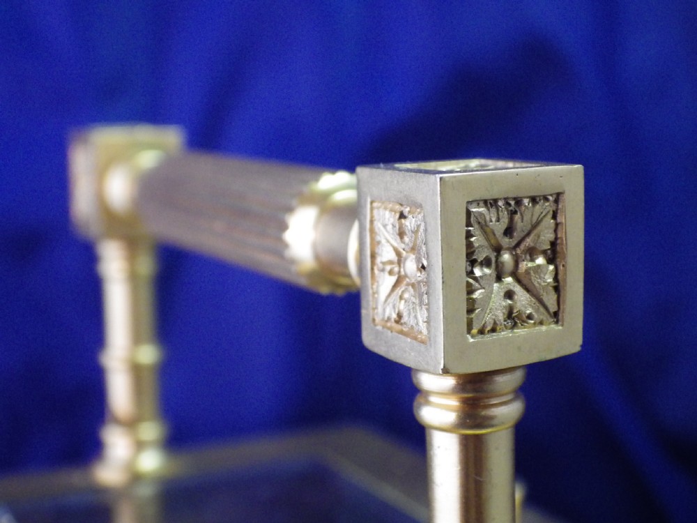 A gilt brass French repeating carriage clock featuring fluted corner columns, an intricate floral dial plate with enamel numerals, and a top carrying handle. View X