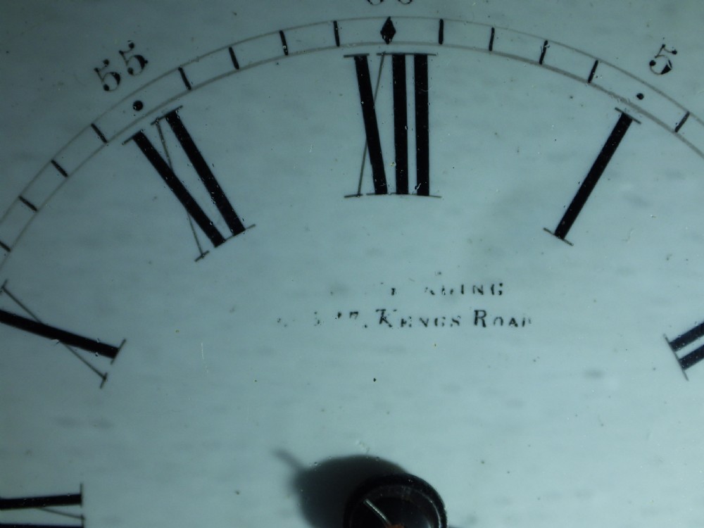 A rectangular gilt brass carriage clock with bevelled glass panels, a top carrying handle, and a white enamel dial with Roman numerals. View IX