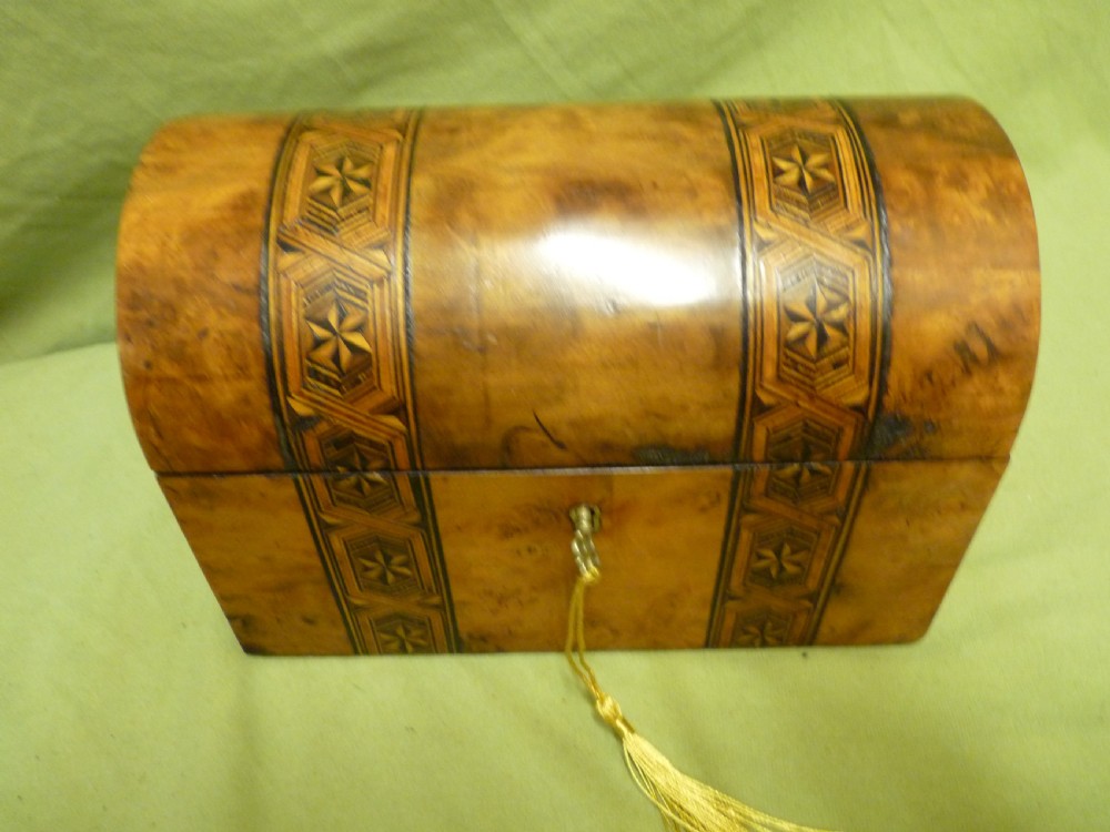 An open Victorian burr walnut tea caddy showcasing two interior lidded compartments and exterior geometric marquetry inlay. View III