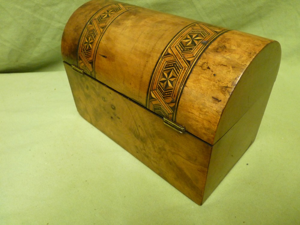 An open Victorian burr walnut tea caddy showcasing two interior lidded compartments and exterior geometric marquetry inlay. View IV