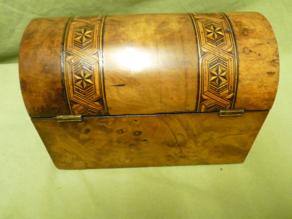 An open Victorian burr walnut tea caddy showcasing two interior lidded compartments and exterior geometric marquetry inlay. View VI