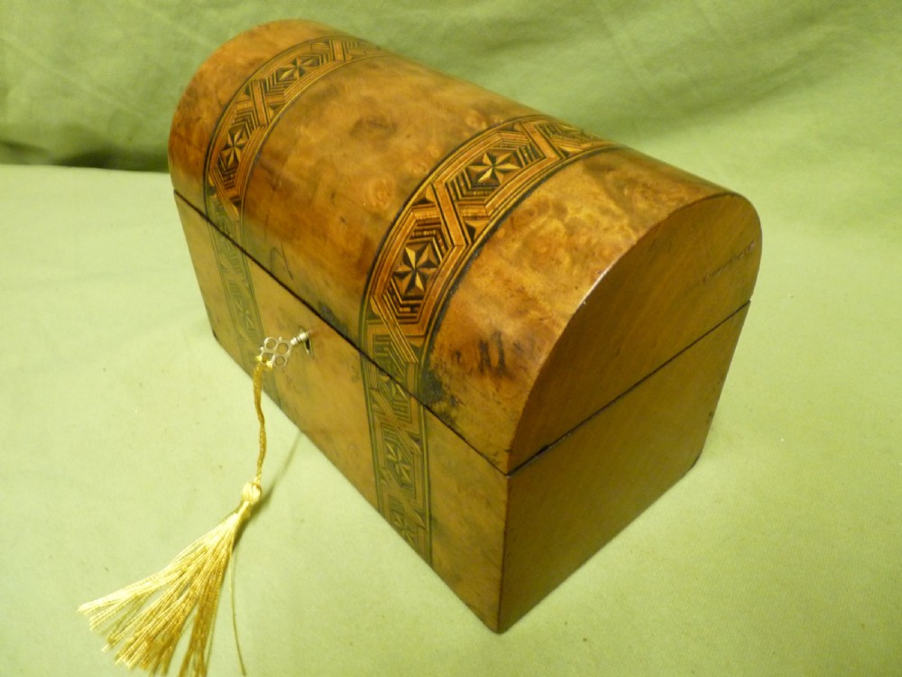 An open Victorian burr walnut tea caddy showcasing two interior lidded compartments and exterior geometric marquetry inlay. View IX