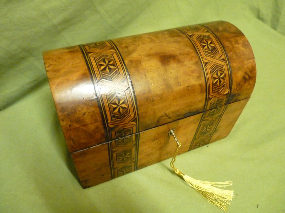 An open Victorian burr walnut tea caddy showcasing two interior lidded compartments and exterior geometric marquetry inlay. View XI