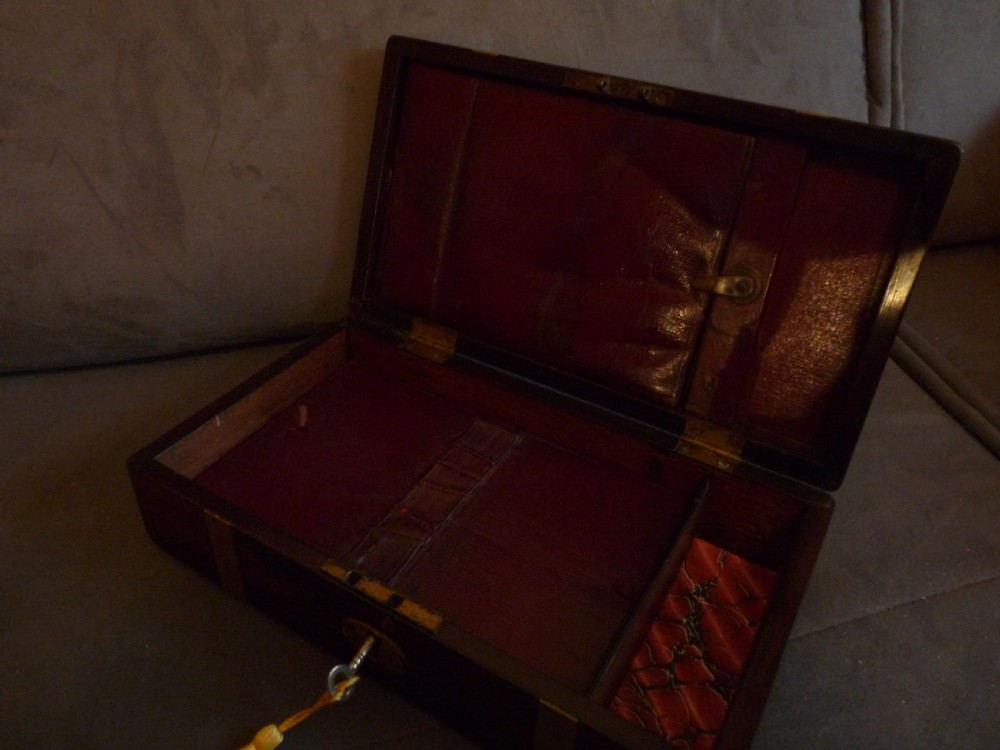 A dark rosewood rectangular box featuring polished brass straps across the lid and front with a central brass plaque and keyhole. View XI