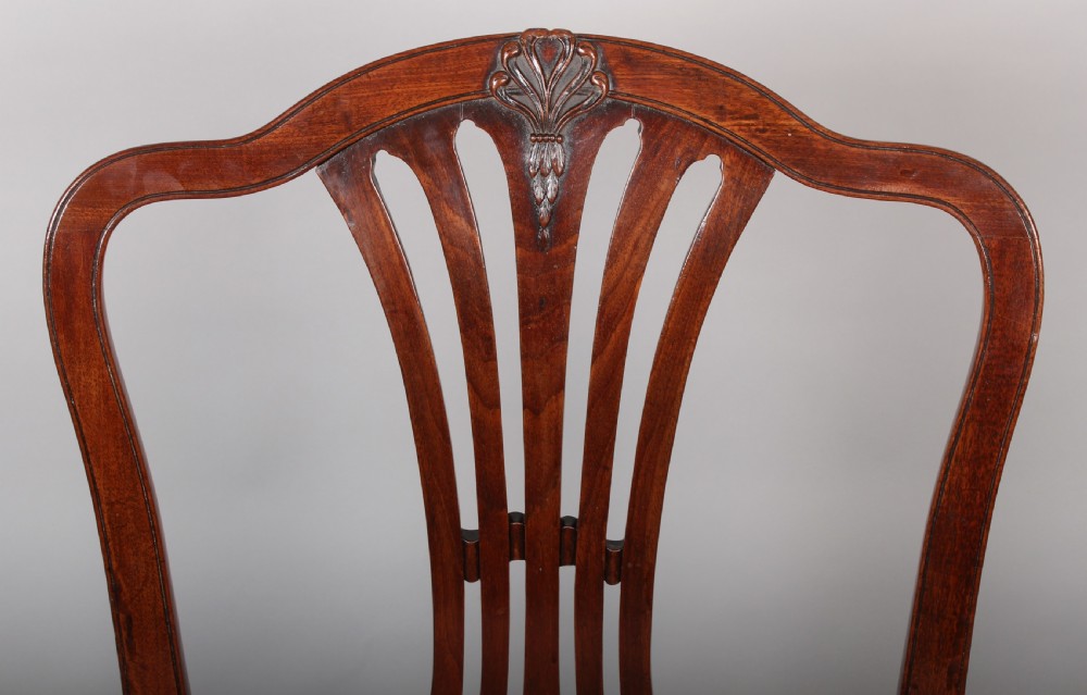 A pair of George III period mahogany side chairs featuring pierced back splats and seats upholstered in coral patterned damask. View II