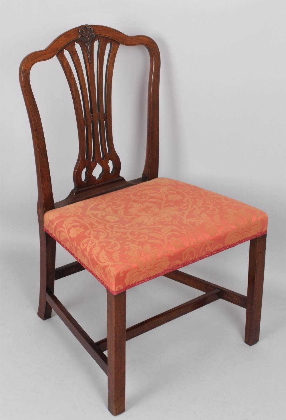 A pair of George III period mahogany side chairs featuring pierced back splats and seats upholstered in coral patterned damask. View III