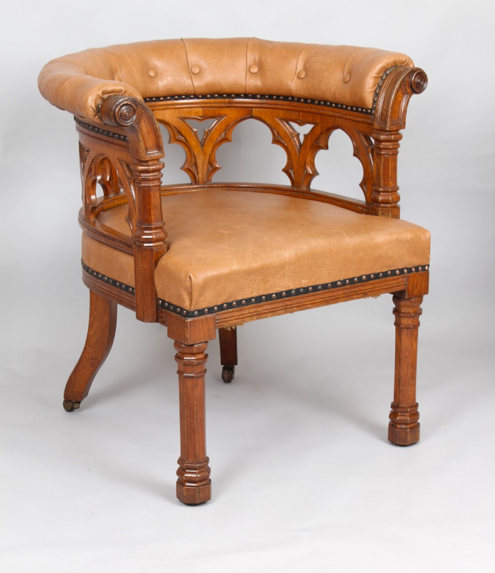 Victorian golden-oak tub armchair in the Gothic Revival manner