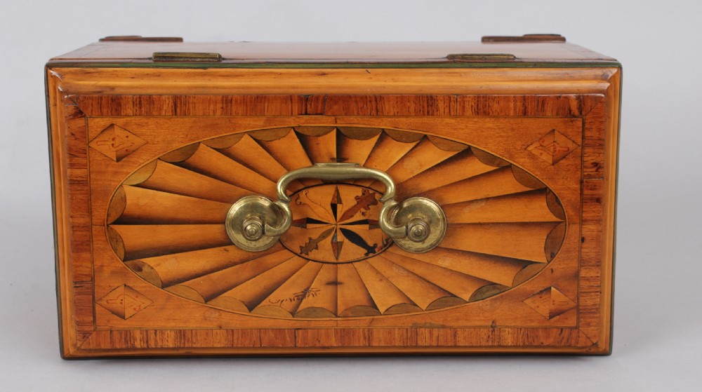 A George III rectangular satinwood tea caddy featuring marquetry oval medallions, fan patterns, a brass top handle, and bracket feet. View II