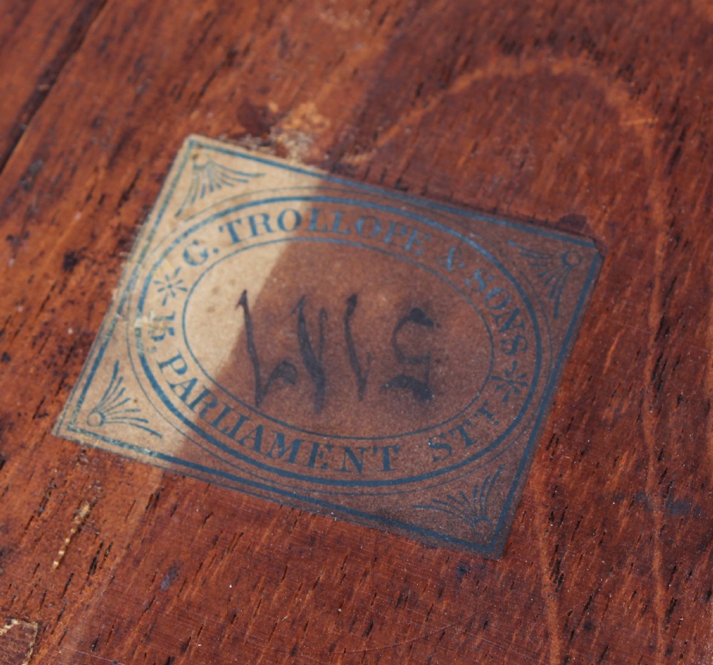 A French Rococo style burr walnut writing table featuring cabriole legs, ornate brass mounts, and a dark brown leather writing top. View VII