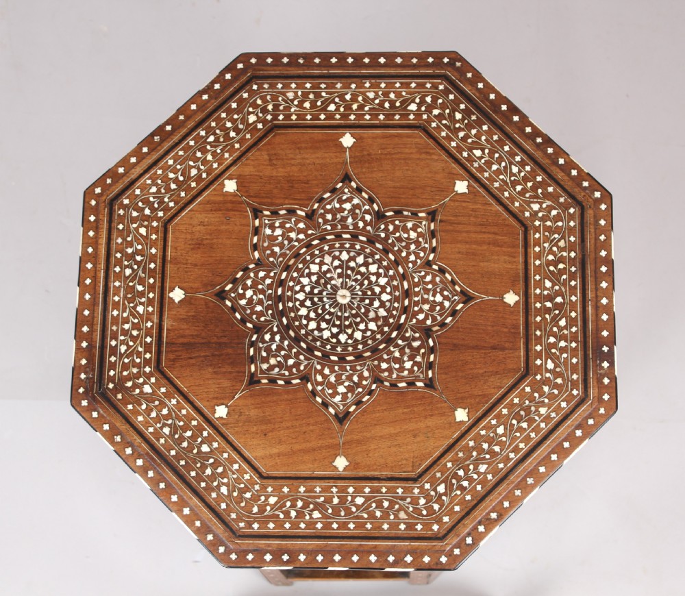 A nineteenth-century octagonal Anglo-Indian side table crafted from warm brown hardwood with elaborate floral star bone inlay and arched panel bases. View III