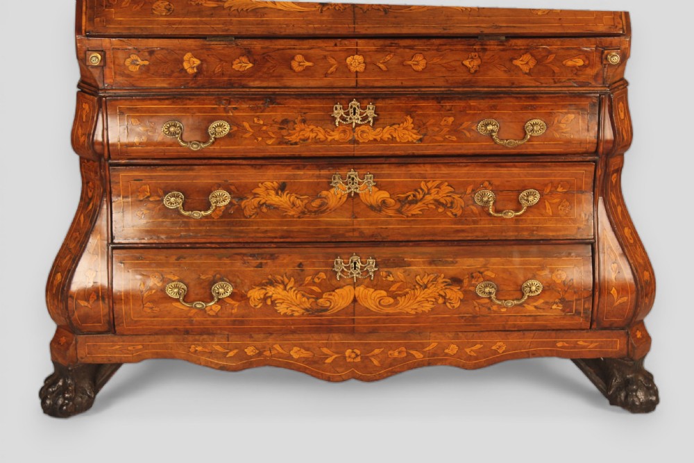 An 18th-century walnut slant-front bureau featuring intricate floral marquetry, three curved bombe drawers, brass drop handles, and carved feet. View II