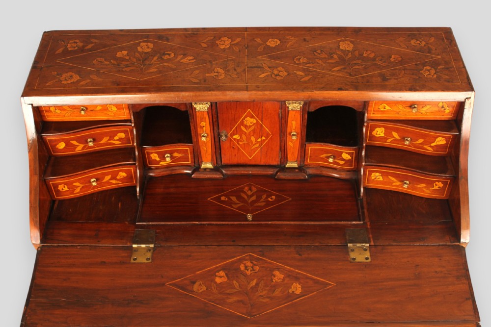 An 18th-century walnut slant-front bureau featuring intricate floral marquetry, three curved bombe drawers, brass drop handles, and carved feet. View III