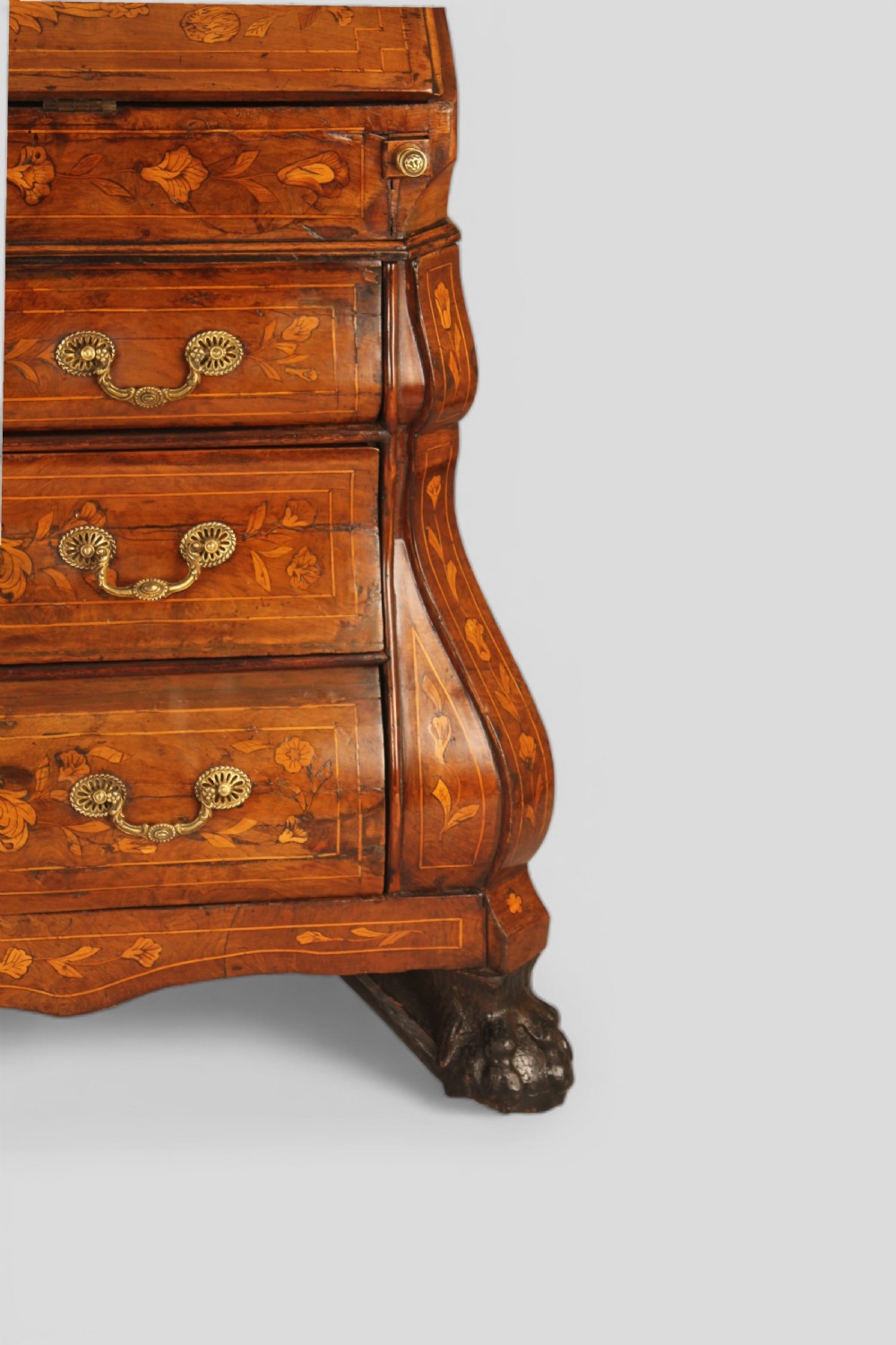 An 18th-century walnut slant-front bureau featuring intricate floral marquetry, three curved bombe drawers, brass drop handles, and carved feet. View IV