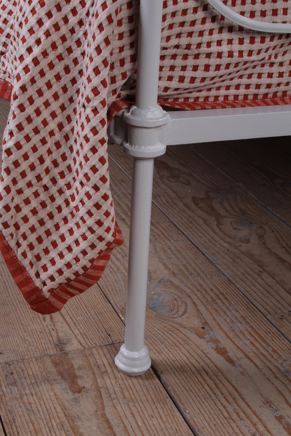 An off-white painted iron bedstead featuring a curved headboard and footboard with Celtic-style decorative metal scrollwork. View II