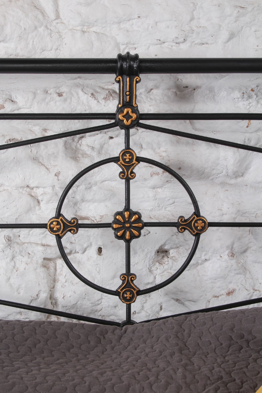 A Victorian super king black iron bed frame featuring geometric rod work and central brass highlights on the headboard. View III