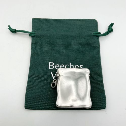 fig 1. An Edwardian sterling silver vesta case with a contoured rectangular shape, side suspension ring, and hinged lid.