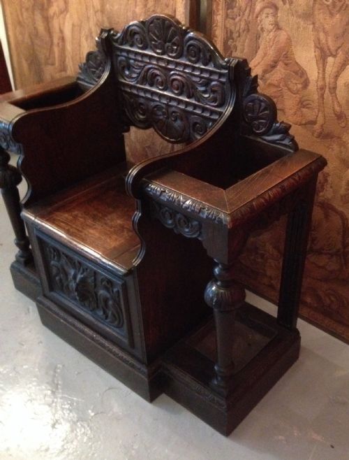 fig 1. Victorian carved oak hall seat flanked by stick stands circa 1880