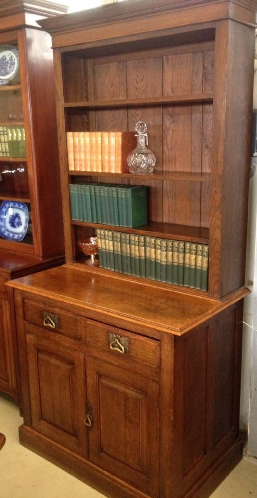 fig 1. Arts and crafts solid oak bookcase over cupboard. Original brass handles