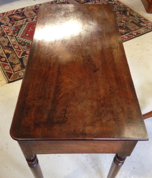 fig 1. Late Georgian mahogany three drawer side table on turned legs
