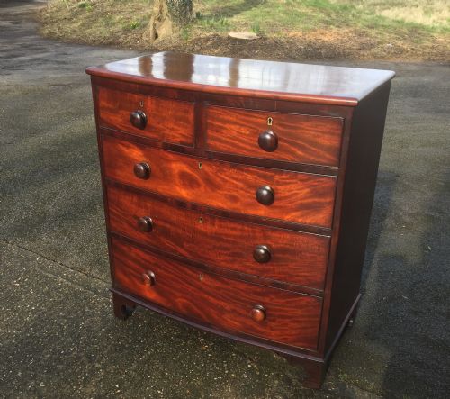 fig 1. Antique Georgian flame mahogany bow front chest of drawers