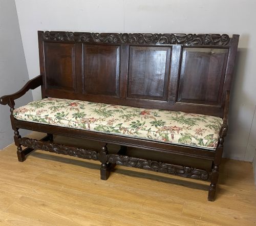 GEORGIAN CARVED OAK FOUR PANEL SETTLE