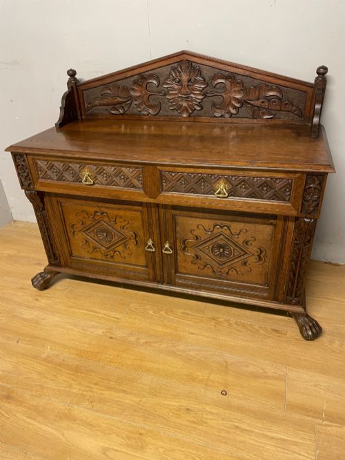 C19th Solid Oak Arts and Crafts Sideboard with Carved Green Man Decoration