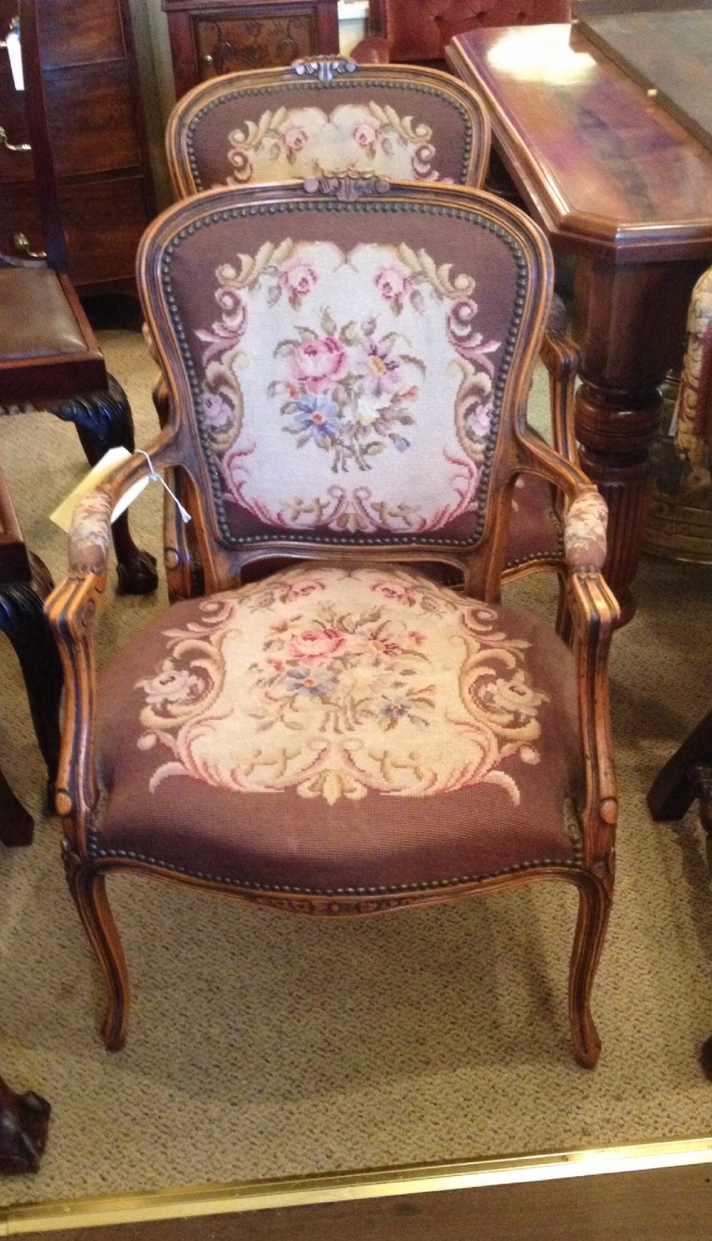 Antique pair of French walnut armchairs. Original needlepoint upholstery