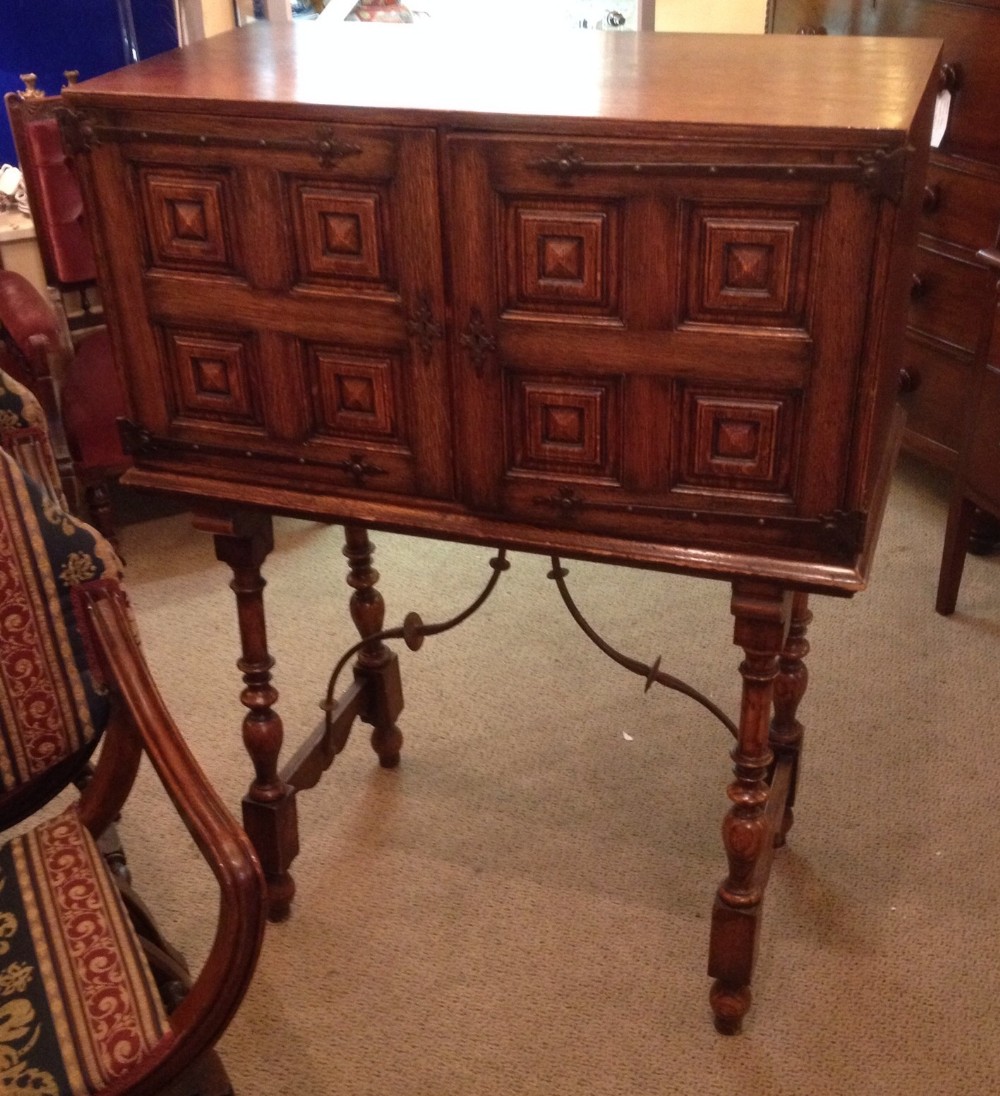 Antique Jacobean style Waring and Gillow drinks cabinet in solid oak circa 1910