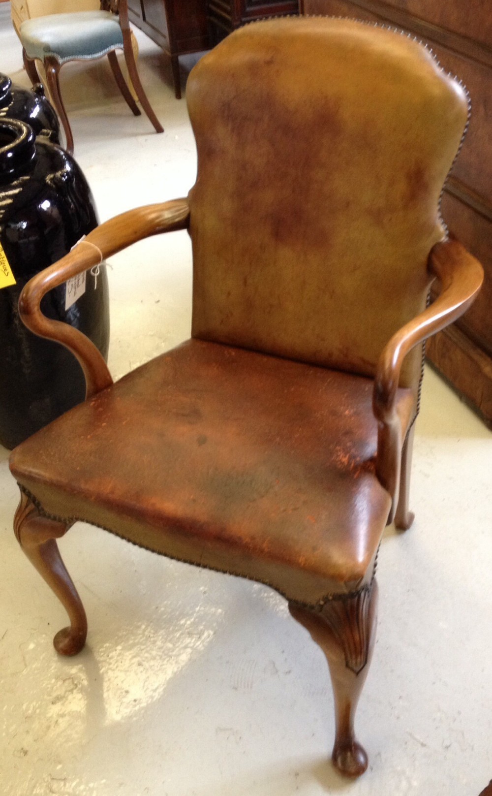 Leather desk chair with crook arms and carved cabriole legs circa 1920