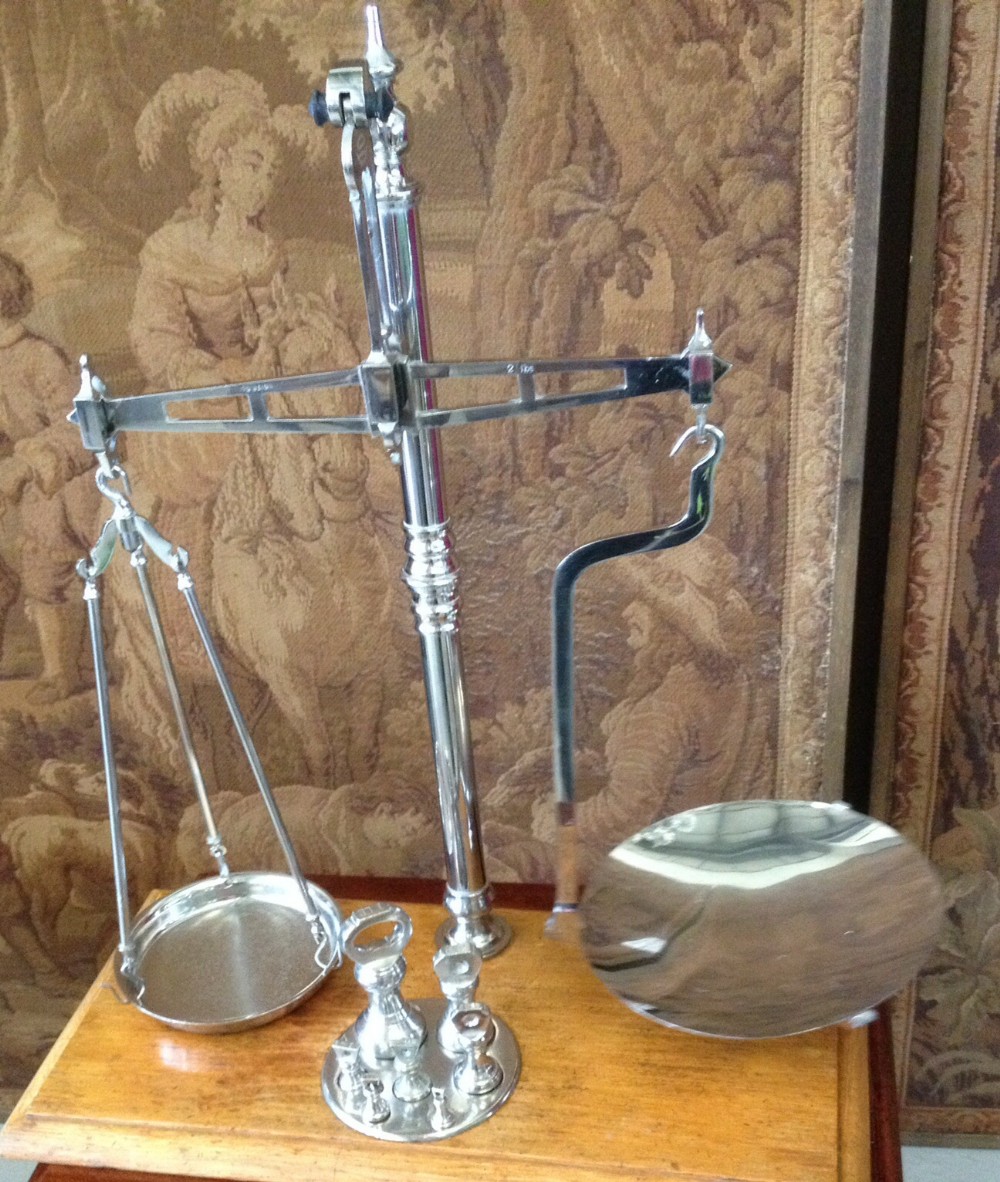 Antique chrome scales from the Manchester Coop with weights .