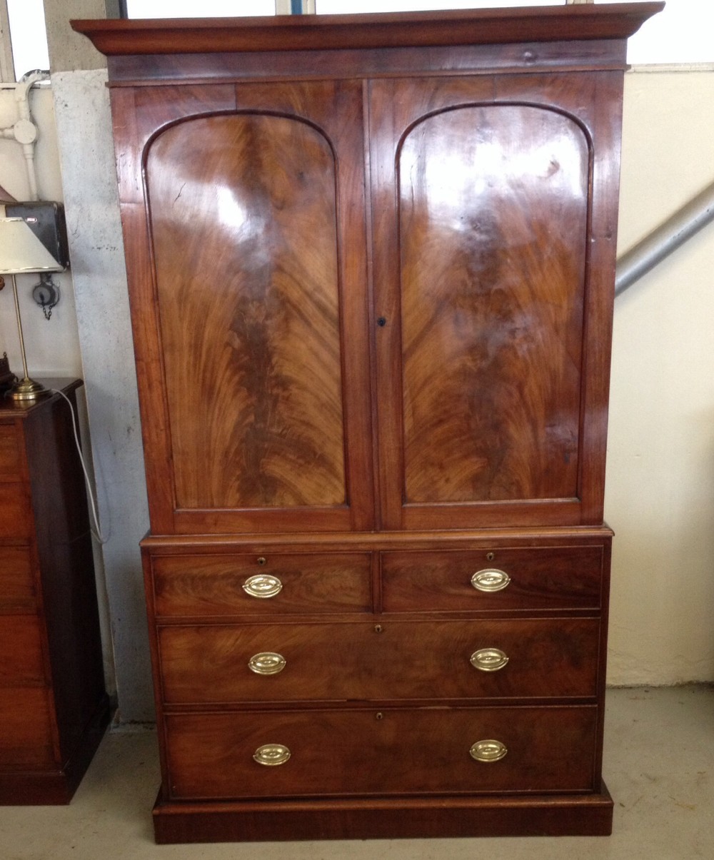 Early Victorian clothes press with flame mahogany front 