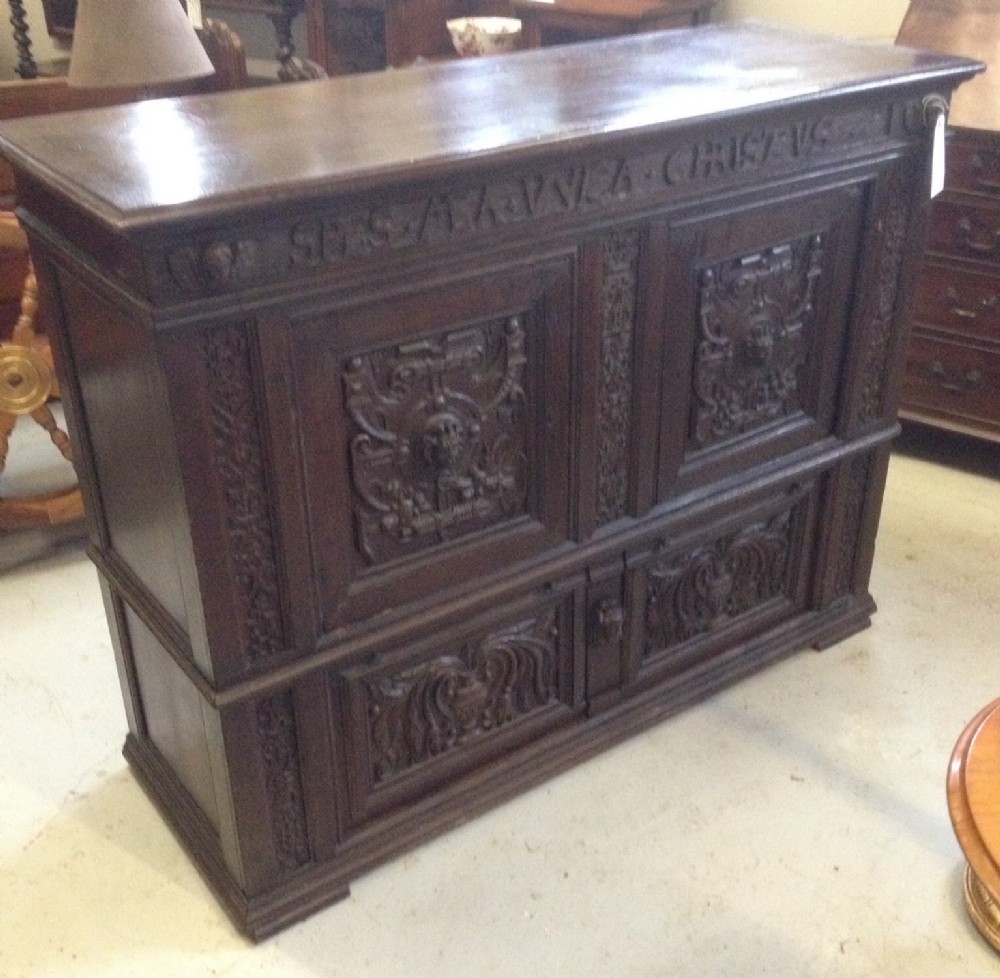 Antique beautifully carved oak ecclesiastical cupboard over drawers